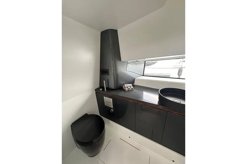  Yacht Photos Pics Modern bathroom in 2025 Maori 46 yacht with sleek black fixtures and minimalist design.