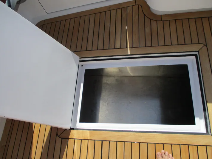 Barratuna Yacht Photos Pics Open storage compartment on 2008 Custom Carolina 53 Sculley boat with teak flooring.