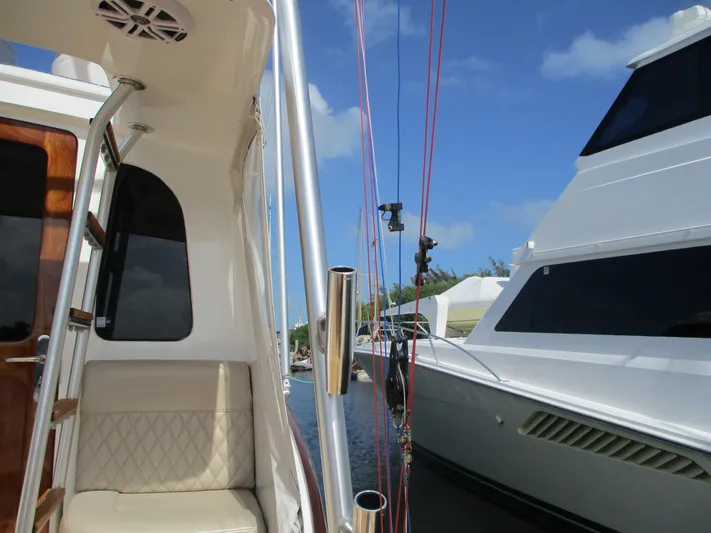 Barratuna Yacht Photos Pics 2008 Custom Carolina 53 Sculley yacht docked, featuring fishing rods and luxurious seating.