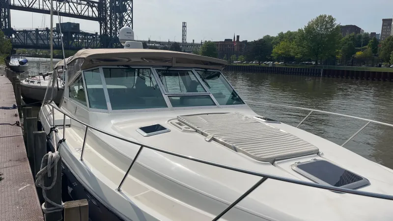 Matilda Bay Yacht Photos Pics 1997 Tiara Yachts 3500 Express docked by a river with a bridge in the background.