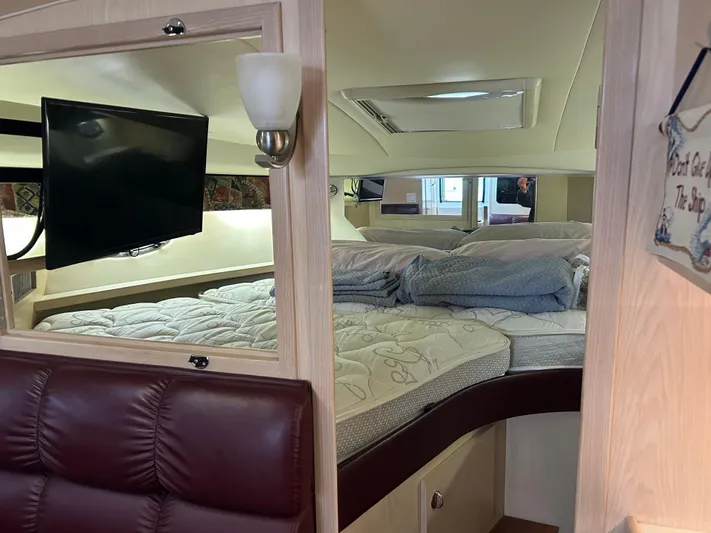 Matilda Bay Yacht Photos Pics 1997 Tiara Yachts 3500 Express cabin interior with bed, TV, and seating area.