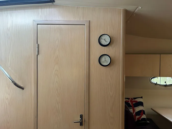 Matilda Bay Yacht Photos Pics Interior of 1997 Tiara Yachts 3500 Express with wooden door and nautical decor.