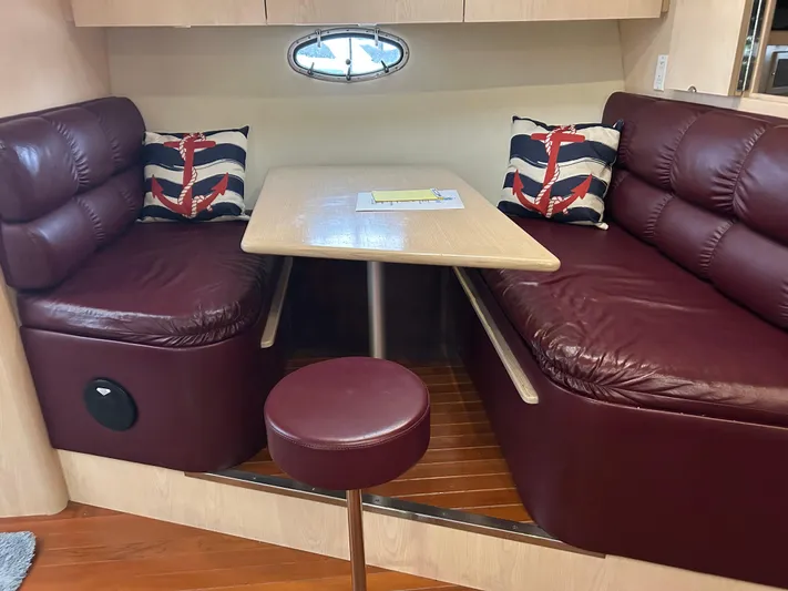 Matilda Bay Yacht Photos Pics 1997 Tiara Yachts 3500 Express interior with maroon leather seating and nautical-themed cushions.