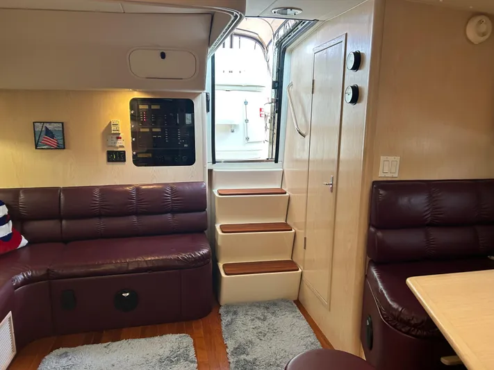 Matilda Bay Yacht Photos Pics Interior of 1997 Tiara Yachts 3500 Express with maroon seating and wooden steps.