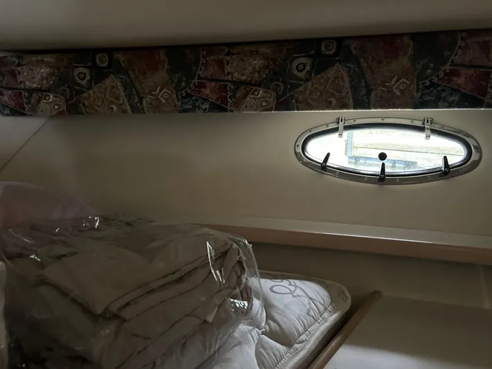 Matilda Bay Yacht Photos Pics 1997 Tiara Yachts 3500 Express cabin interior with bedding and porthole window.