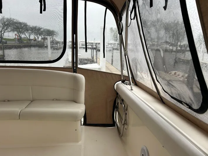 Matilda Bay Yacht Photos Pics 1997 Tiara Yachts 3500 Express interior with white seating and marina view.