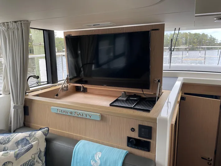 Sweetest Southern Comfort Yacht Photos Pics Interior of 2022 Beneteau ST48 yacht with TV, cozy seating, and nautical decor.