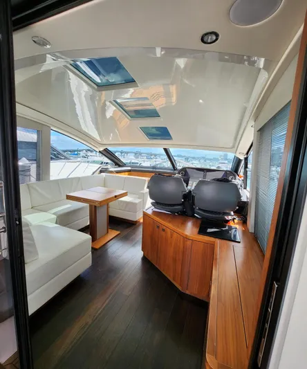  Yacht Photos Pics Interior of 2018 Sunseeker Predator yacht with modern seating and panoramic windows.
