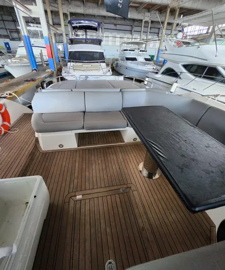  Yacht Photos Pics 2018 Sunseeker Predator yacht interior with wooden deck and seating area.