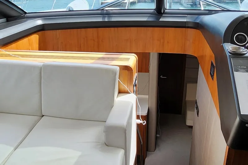  Yacht Photos Pics Interior of 2018 Sunseeker Predator yacht with white leather seating and wooden accents.