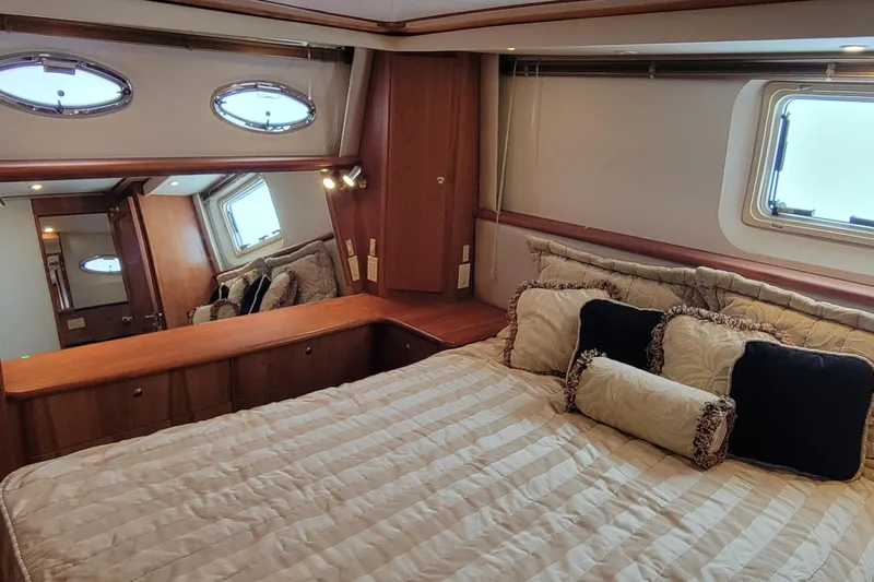 Escape II Sea Yacht Photos Pics Luxurious bedroom interior of 2003 Silverton 453 Motor Yacht with elegant bedding and wood accents.