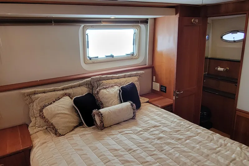 Escape II Sea Yacht Photos Pics Luxurious bedroom interior of 2003 Silverton 453 Motor Yacht with elegant bedding and wood accents.