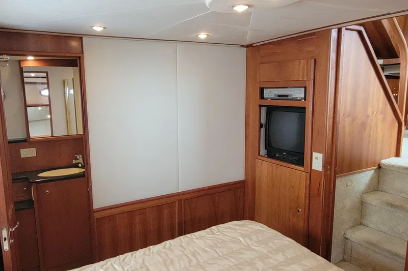 Escape II Sea Yacht Photos Pics Interior of 2003 Silverton 453 Motor Yacht with TV, sink, and wooden cabinetry.
