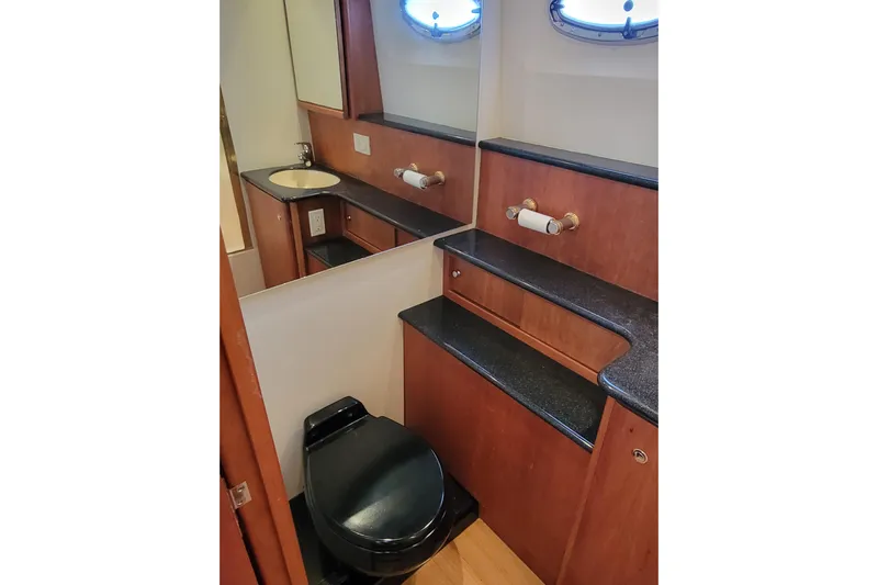 Escape II Sea Yacht Photos Pics Luxurious bathroom in 2003 Silverton 453 Motor Yacht with modern fixtures and wood accents.