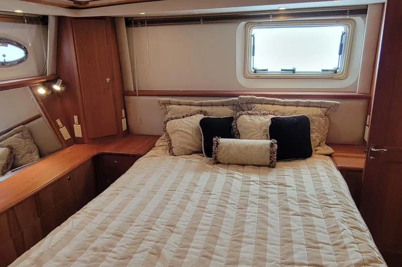 Escape II Sea Yacht Photos Pics Luxurious bedroom interior of 2003 Silverton 453 Motor Yacht with elegant bedding and wood accents.