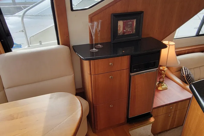 Escape II Sea Yacht Photos Pics Interior of 2003 Silverton 453 Motor Yacht with elegant wood cabinetry and seating.