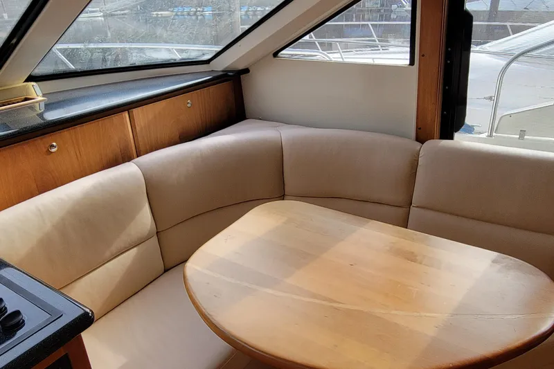 Escape II Sea Yacht Photos Pics Interior of 2003 Silverton 453 Motor Yacht with cozy seating and wooden table.