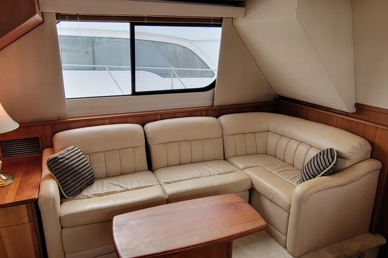 Escape II Sea Yacht Photos Pics Luxurious interior of 2003 Silverton 453 Motor Yacht with beige leather sofa and wooden accents.