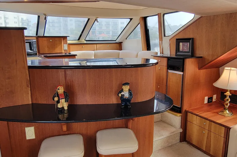 Escape II Sea Yacht Photos Pics Interior of 2003 Silverton 453 Motor Yacht with wooden cabinetry and nautical decor.