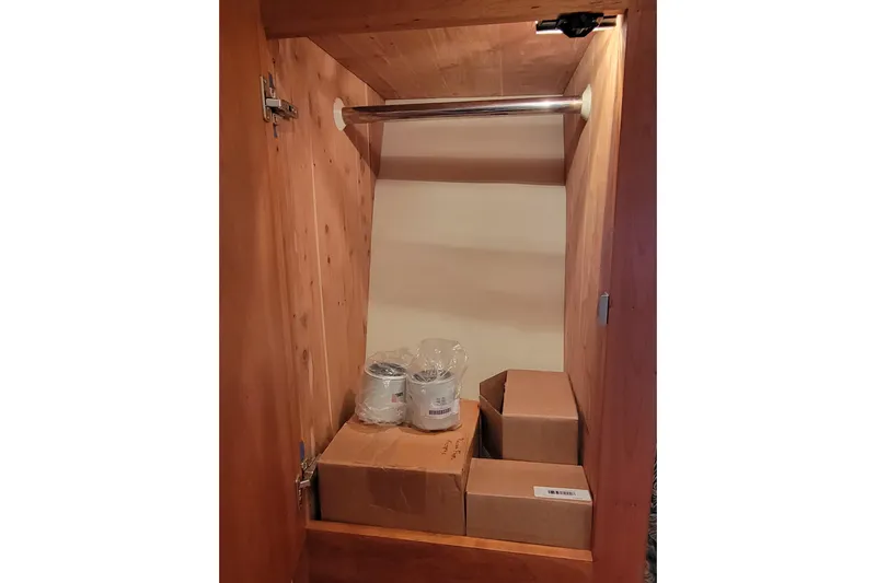 Escape II Sea Yacht Photos Pics Wooden closet interior on 2003 Silverton 453 Motor Yacht, with boxes and cans.