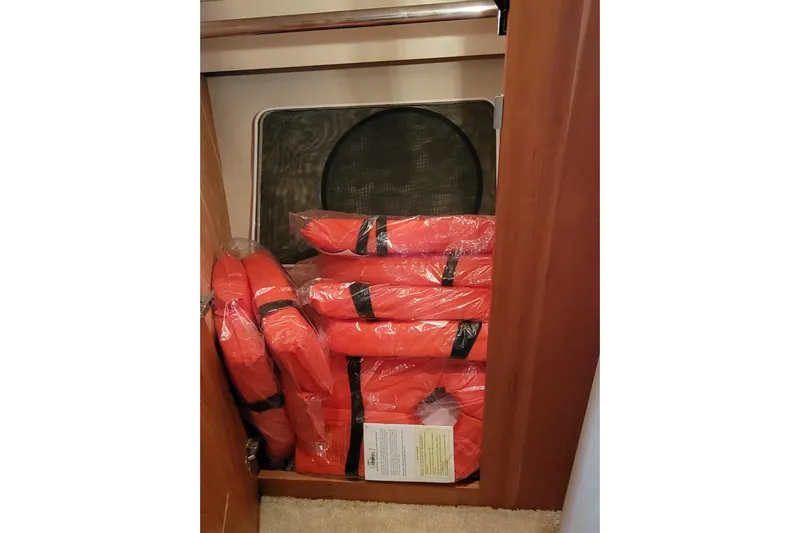 Escape II Sea Yacht Photos Pics Stacked orange life jackets in a 2003 Silverton 453 Motor Yacht storage compartment.