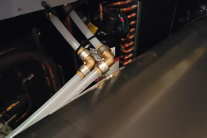 Escape II Sea Yacht Photos Pics Engine room of 2003 Silverton 453 Motor Yacht showing pipes and mechanical components.