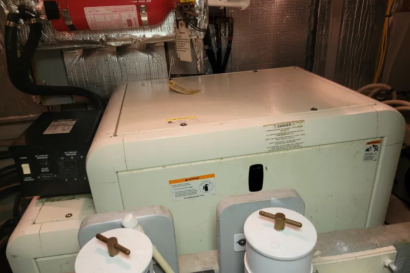 Escape II Sea Yacht Photos Pics Engine room of a 2003 Silverton 453 Motor Yacht with generator and fire extinguisher.