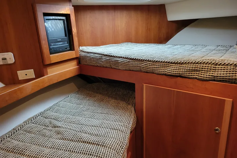 Escape II Sea Yacht Photos Pics 2003 Silverton 453 Motor Yacht cabin with bunk beds and built-in TV.
