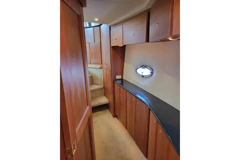 Escape II Sea Yacht Photos Pics 2003 Silverton 453 Motor Yacht interior with wood cabinetry and porthole window.