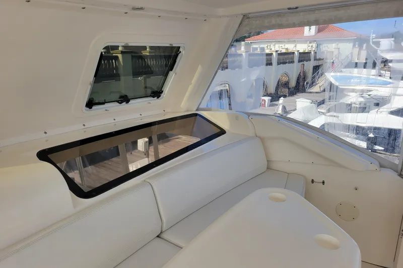 Escape II Sea Yacht Photos Pics Interior view of 2003 Silverton 453 Motor Yacht with white seating and window.
