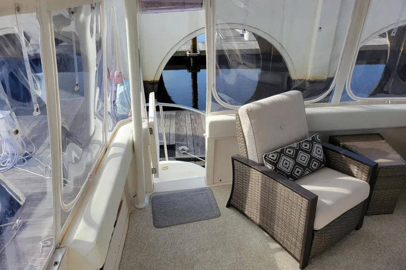 Escape II Sea Yacht Photos Pics 2003 Silverton 453 Motor Yacht interior with wicker chair and geometric cushion.