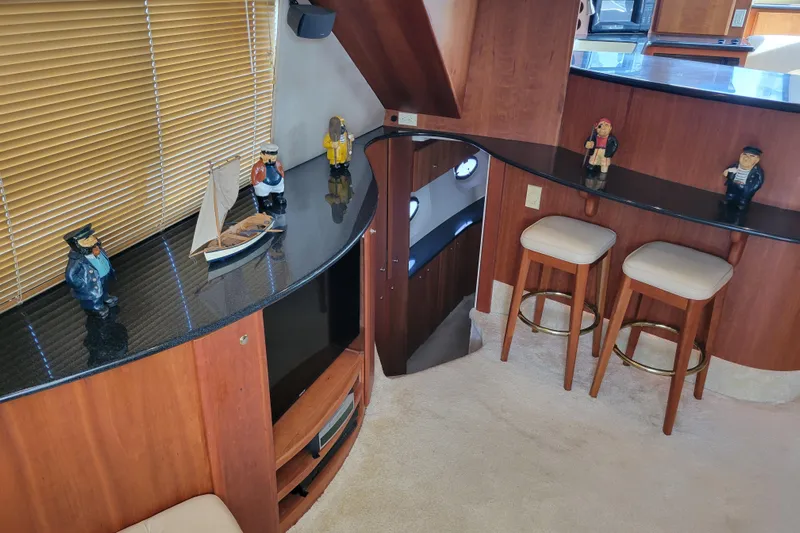 Escape II Sea Yacht Photos Pics Interior of 2003 Silverton 453 Motor Yacht with nautical decor and bar stools.