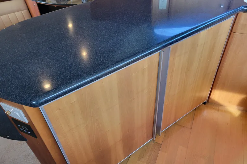 Escape II Sea Yacht Photos Pics 2003 Silverton 453 Motor Yacht interior with sleek countertop and wooden cabinetry.