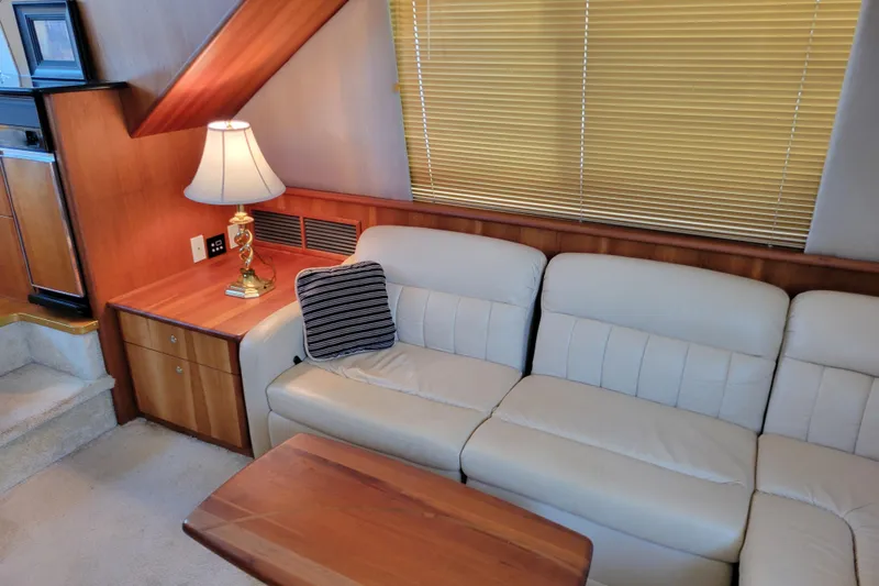 Escape II Sea Yacht Photos Pics Interior of 2003 Silverton 453 Motor Yacht with sofa, lamp, and wooden accents.