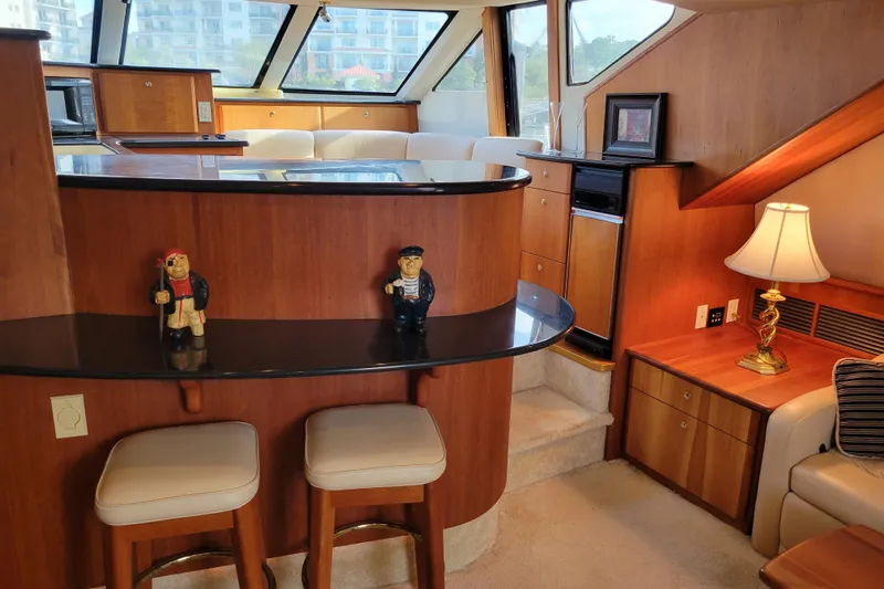 Escape II Sea Yacht Photos Pics Interior of 2003 Silverton 453 Motor Yacht with bar, stools, and nautical decor.