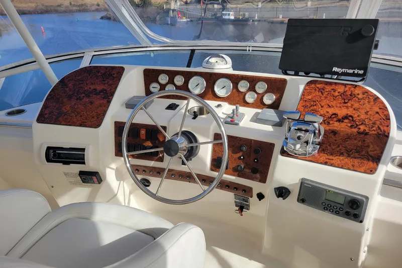 Escape II Sea Yacht Photos Pics 2003 Silverton 453 Motor Yacht helm with wood accents and navigation equipment.