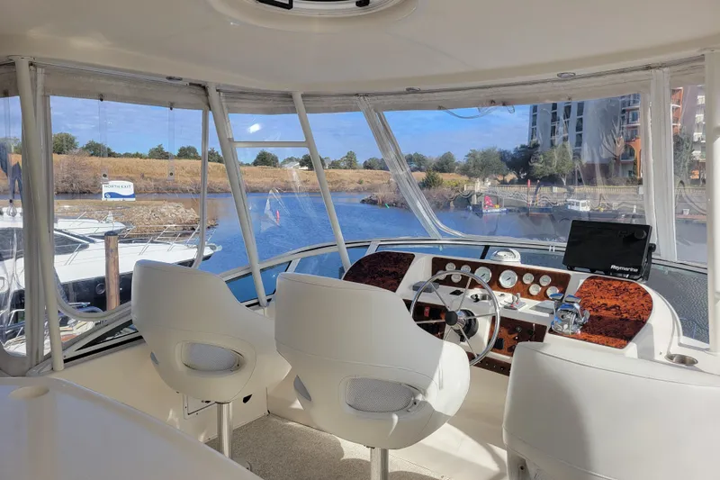 Escape II Sea Yacht Photos Pics 2003 Silverton 453 Motor Yacht helm with dual seats, steering wheel, and navigation equipment.