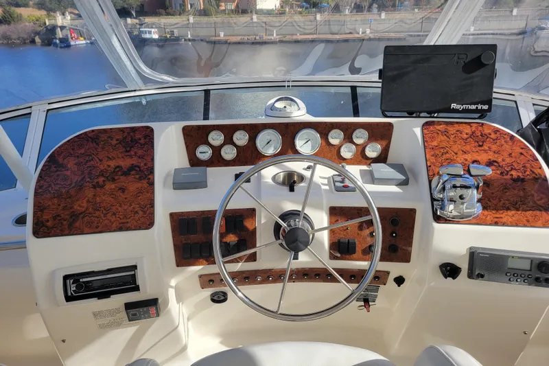Escape II Sea Yacht Photos Pics 2003 Silverton 453 Motor Yacht helm with wood accents and modern navigation equipment.