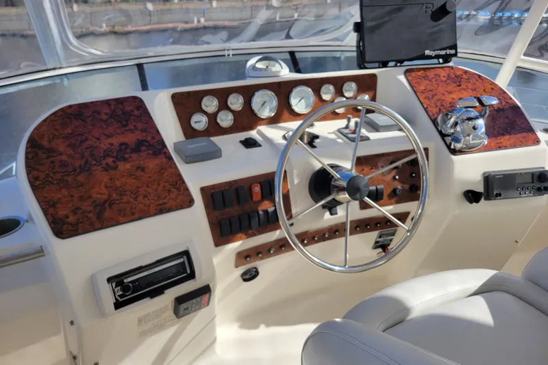 Escape II Sea Yacht Photos Pics 2003 Silverton 453 Motor Yacht helm with wood accents and modern controls.