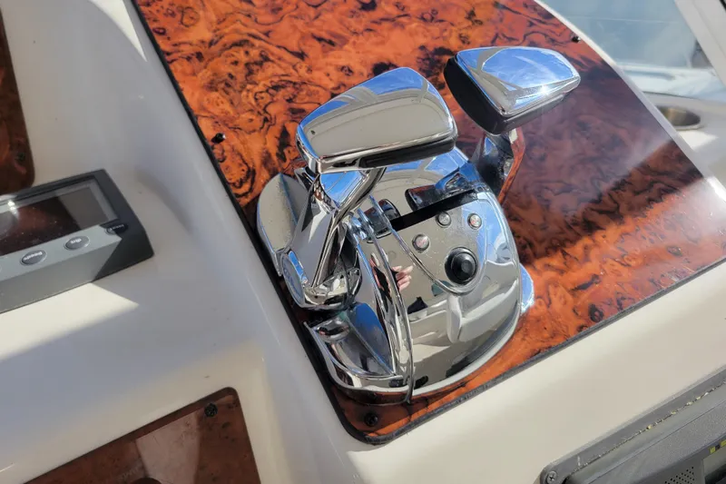 Escape II Sea Yacht Photos Pics Close-up of 2003 Silverton 453 Motor Yacht throttle controls on a wood-patterned panel.