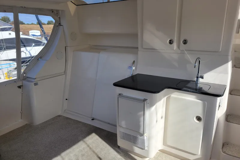 Escape II Sea Yacht Photos Pics Interior of 2003 Silverton 453 Motor Yacht with kitchenette and window view.