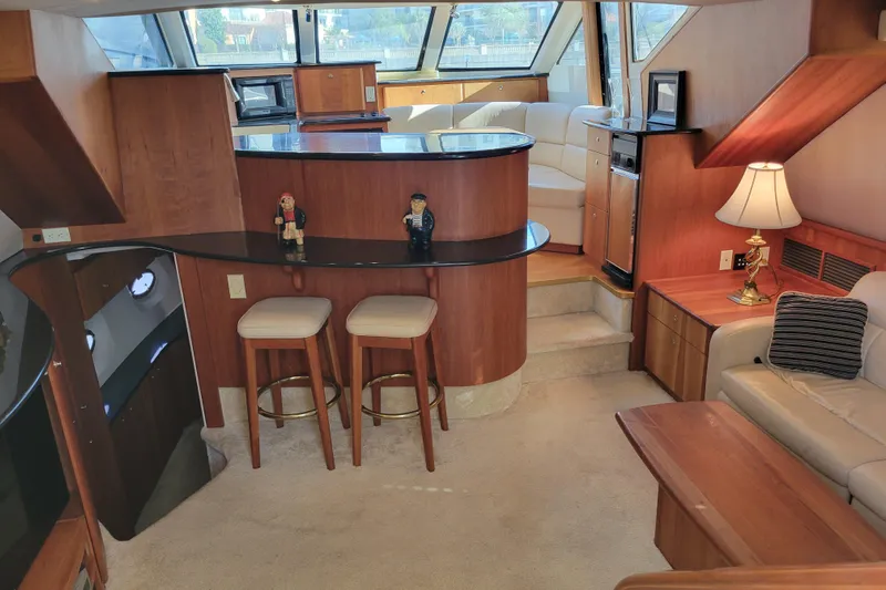 Escape II Sea Yacht Photos Pics Luxurious interior of a 2003 Silverton 453 Motor Yacht with elegant wood finishes.