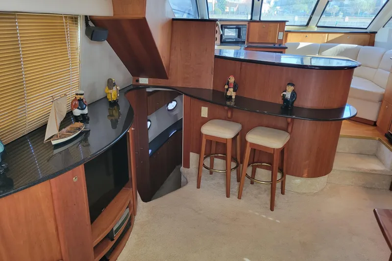 Escape II Sea Yacht Photos Pics Interior of 2003 Silverton 453 Motor Yacht with bar, stools, and nautical decor.