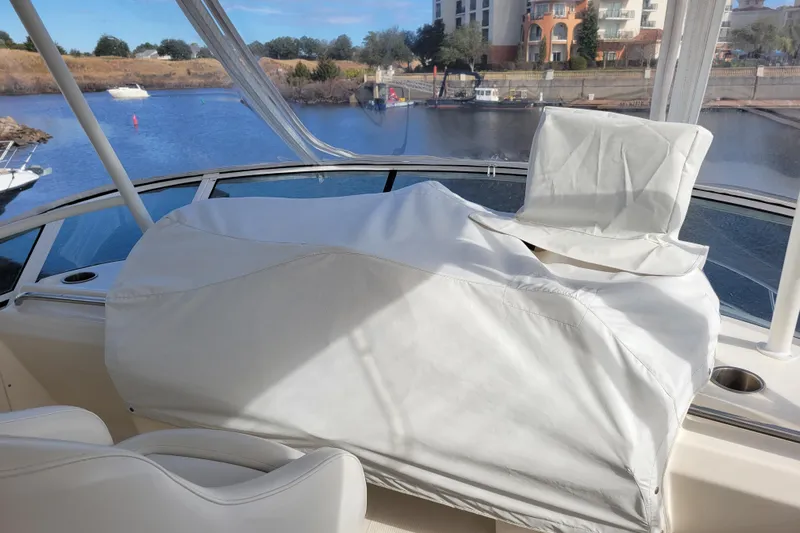 Escape II Sea Yacht Photos Pics 2003 Silverton 453 Motor Yacht helm covered, docked by a scenic waterfront.