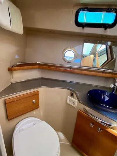 Windless Yacht Photos Pics 2016 Ranger Tugs R-29 S Tug bathroom with modern fixtures and porthole window.
