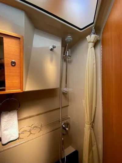 Windless Yacht Photos Pics 2016 Ranger Tugs R-29 S Tug bathroom with shower, wooden accents, and storage.