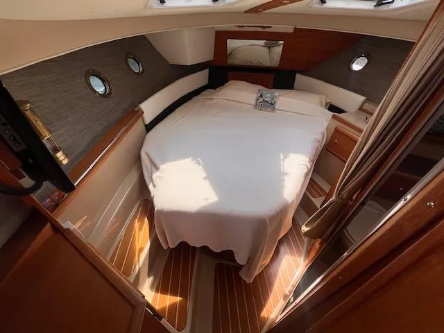 Windless Yacht Photos Pics 2016 Ranger Tugs R-29 S Tug interior cabin with bed and wooden accents.