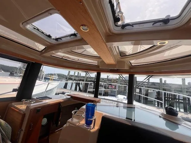 Windless Yacht Photos Pics Interior view of 2016 Ranger Tugs R-29 S Tug with skylights and marina backdrop.