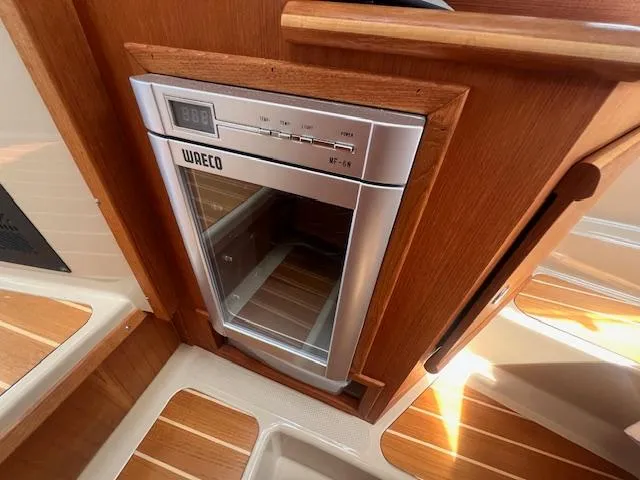 Windless Yacht Photos Pics Compact fridge in 2016 Ranger Tugs R-29 S Tug interior, featuring wood paneling.
