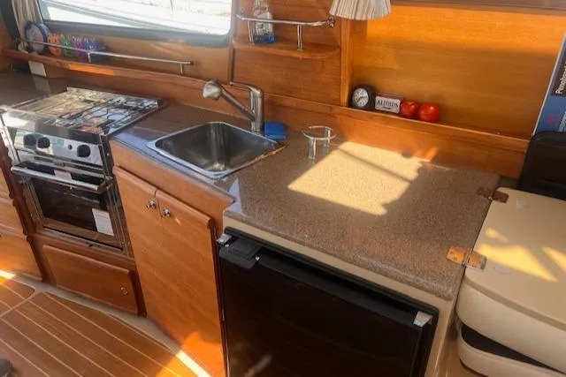 Windless Yacht Photos Pics 2016 Ranger Tugs R-29 S Tug kitchen with stove, sink, and countertop.